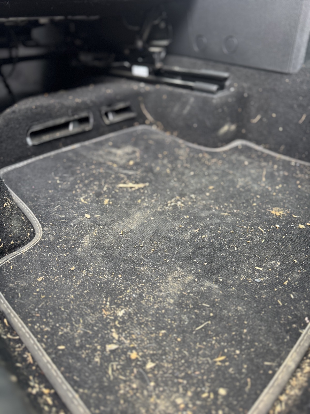 A filthy car footwell before our interior deep clean